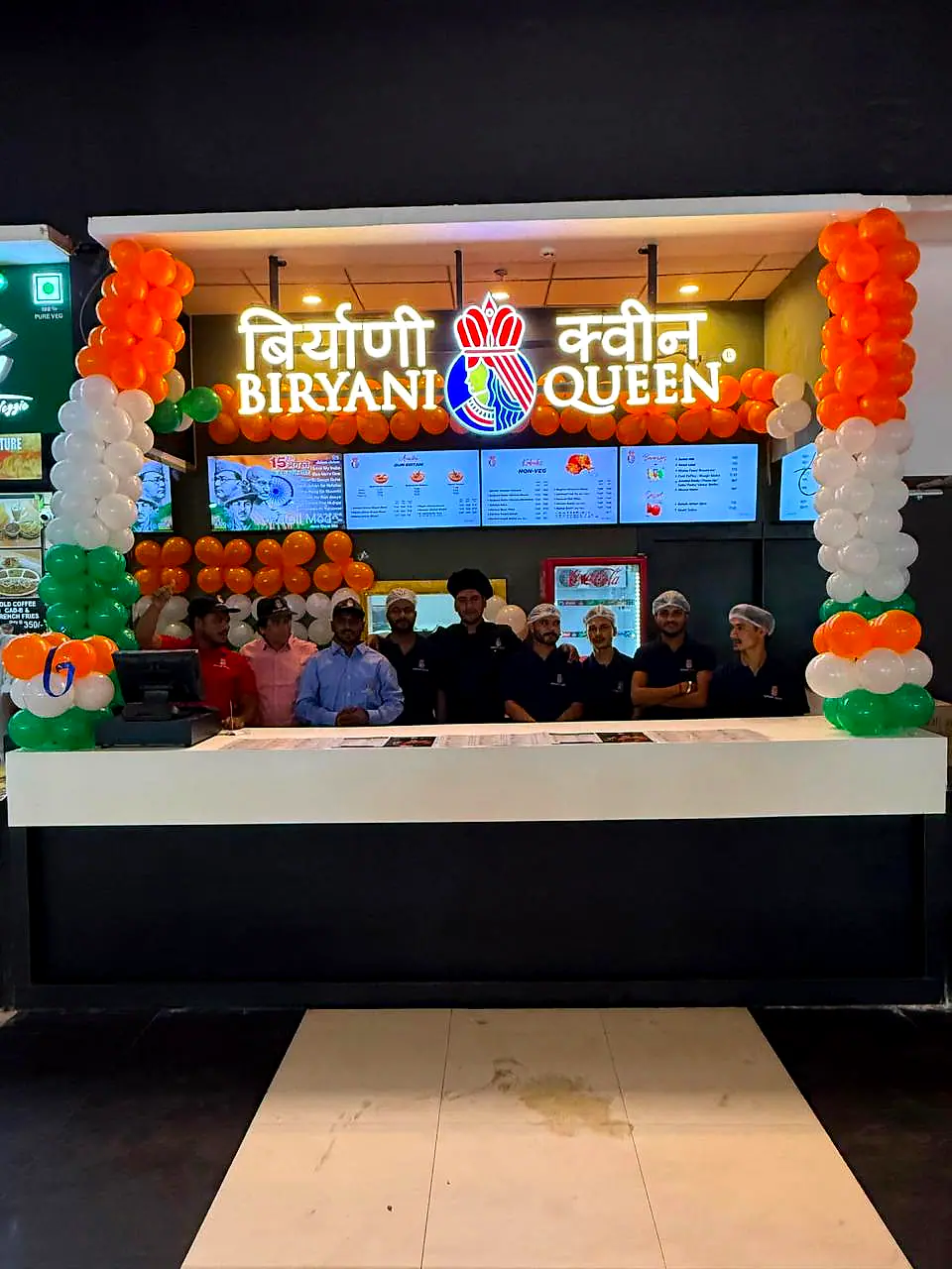 The Biryani Queen team behind the counter on opening day, under tricolour balloons